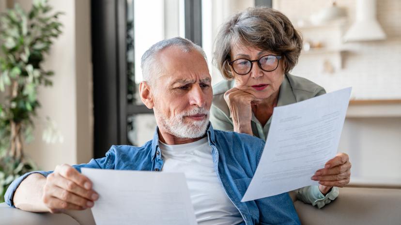 A man and woman looking at papers together.