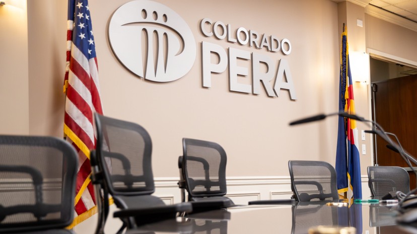 The Colorado PERA Board room with empty chairs and a microphone in view.